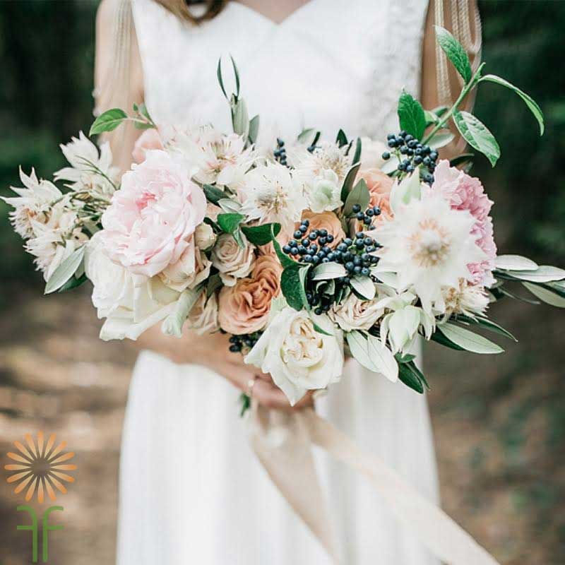 bridal bouquet with peach, cream and pink flowers