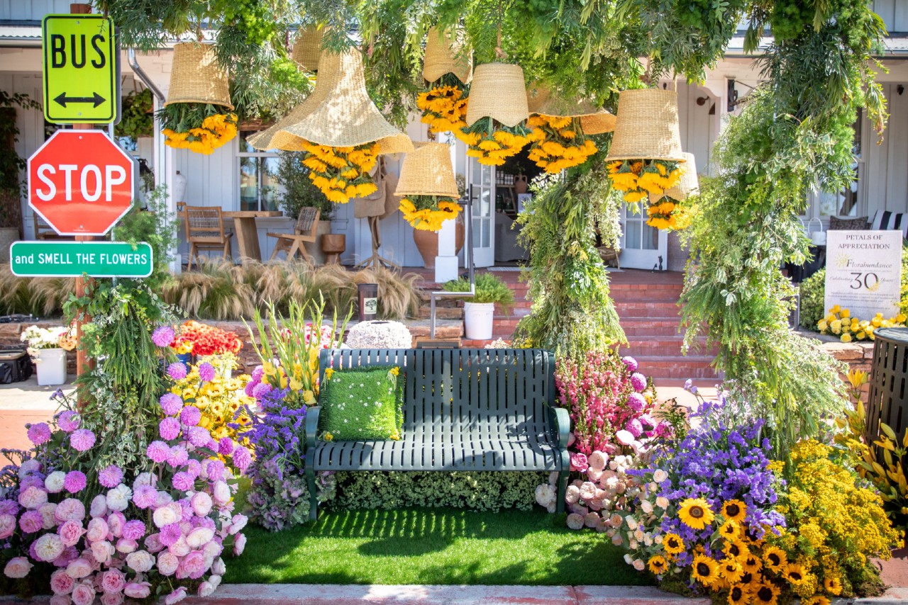 floral decorated bench and stop sign