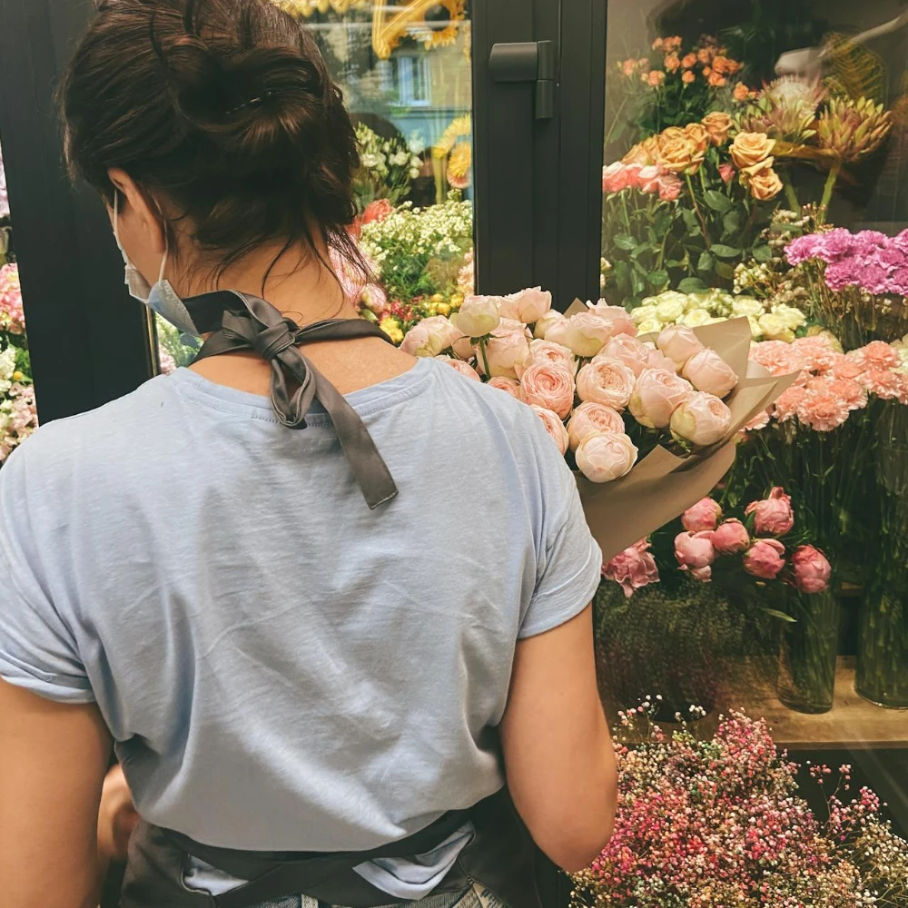 Florist checking flower inventory while preparing for Valentine’s Day